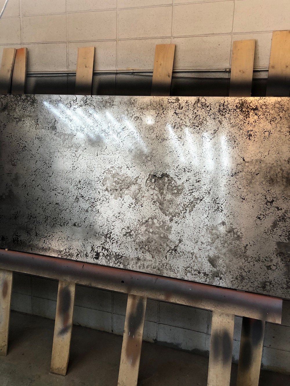 Full sheet of aluminum with a mottled patina