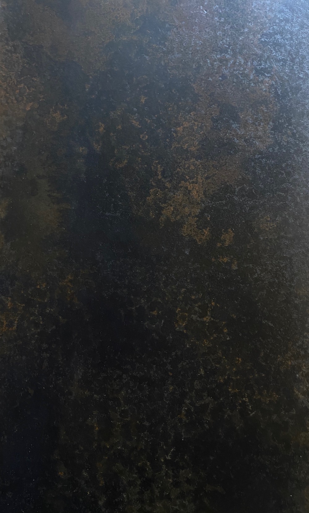 Concrete sample with black and rusted textured finish