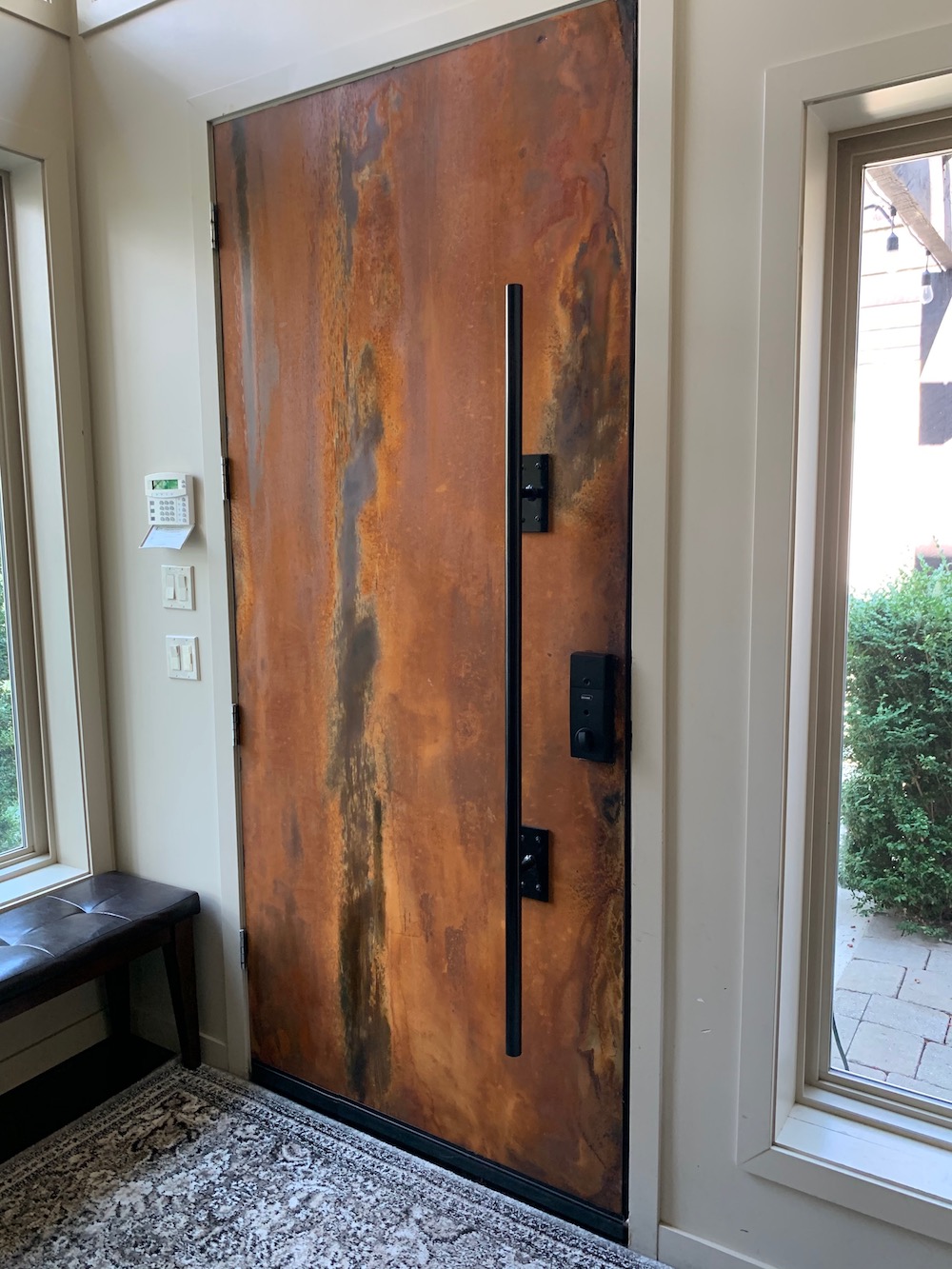 Interior side of entry door with custom rusted panel